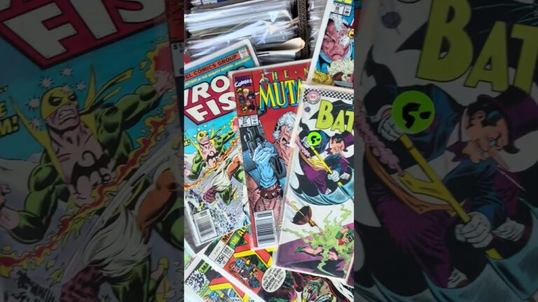 Iron Fist, New Mutants and Batman comic books fanned out over a short box of bagged comics